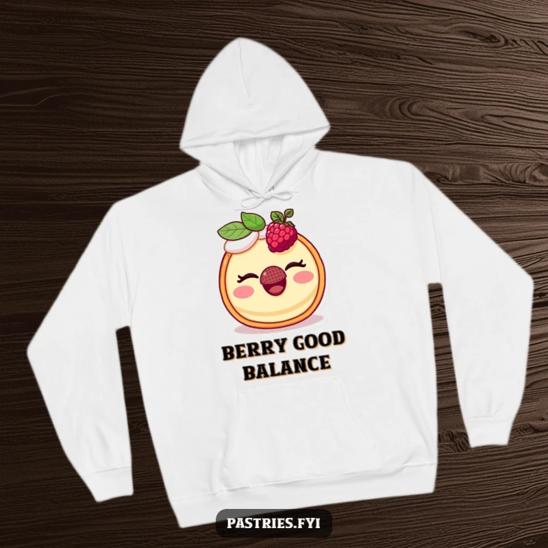Funny hoodie depicting a smiling tart winking while skillfully balancing a red raspberry on its nose, a truly humorous sight.
