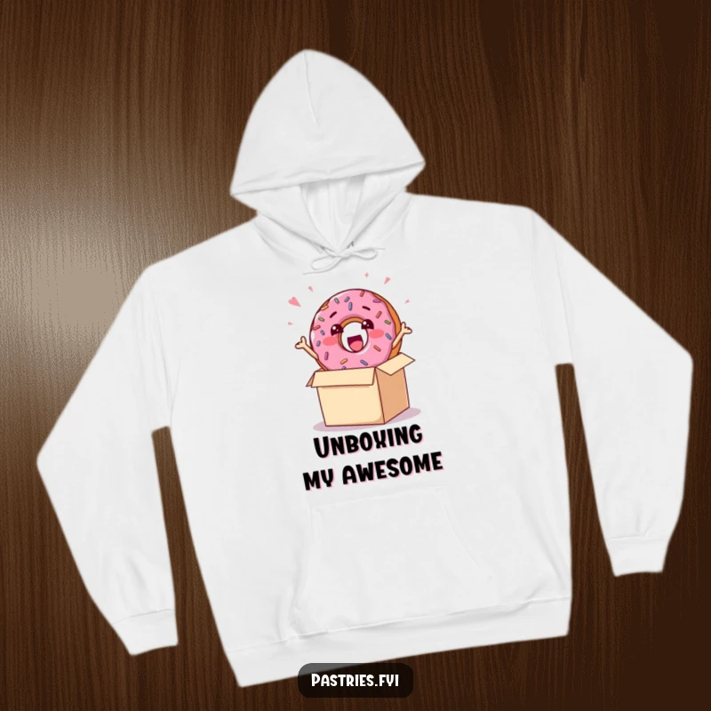 Funny hoodie featuring a cheerful donut character covered in sprinkles, bursting enthusiastically out of a present box, embodying sweet delight.