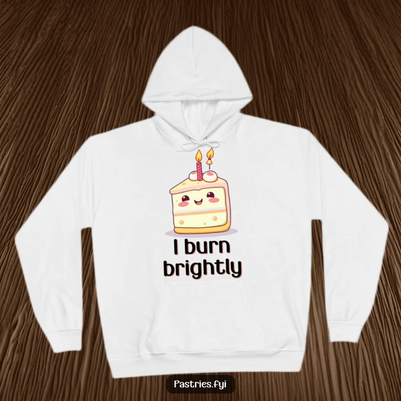 Funny cake slice hoodie with a joyful Kawaii character and a lit candle, embodying festive cheer.