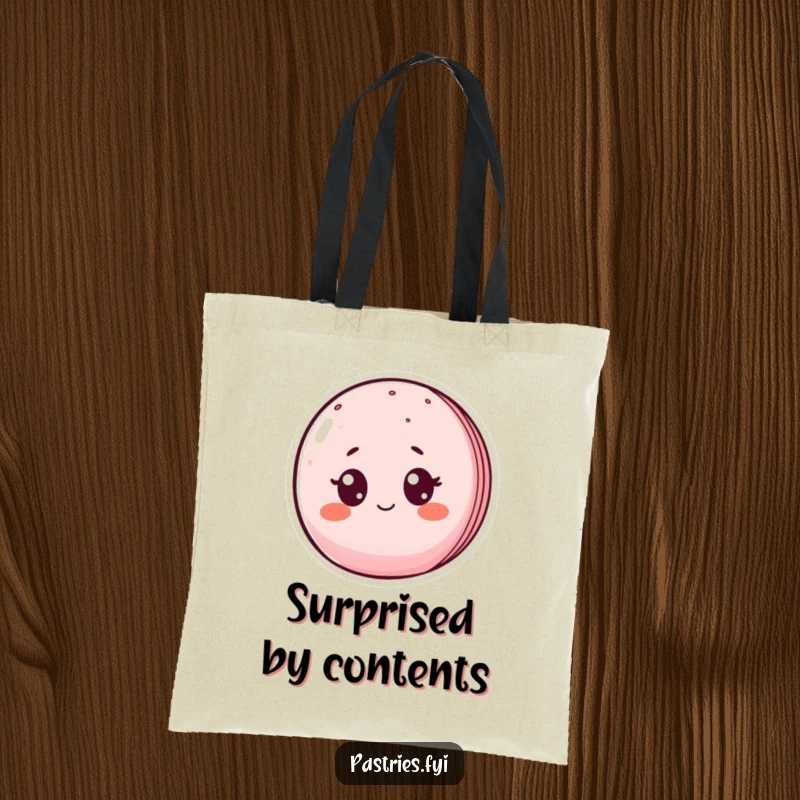 Funny tote bag with a blushing macaron character wide-eyed in surprise, perfect for carrying essentials with a humorous flair.